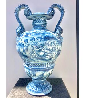 Large majolica vase in turquoise monochrome with serpentine handles and decoration with characters, cherubs and satyrs on a rural background in Savona style, Cantagalli manufacture Florence.     
