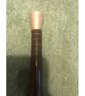 Stick with silver knob with initials, barrel with flexible core covered with wooden discs.     
