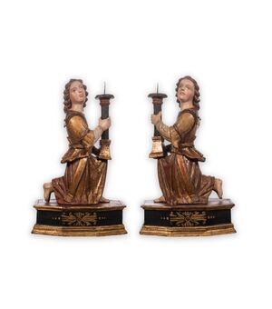 Kneeling angels with candle holders     