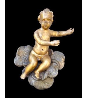 Figura di putto in legno scolpito e dorato  su nuvole dipinte.Liguria