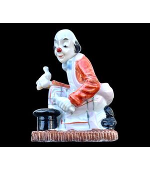 Polychrome porcelain figurine depicting a magician clown. Old Paris. France.     