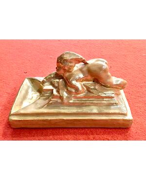 Gold luster majolica ashtray with naked table child. Umbrian Ceramics Company. Gualdo Tadino.     