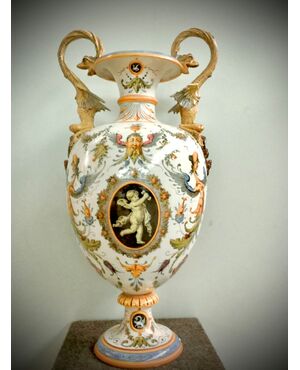 Large majolica vase with dragons handle and Raphaelesque and grotesque decoration with putto in central medallion.Ginori manufacture.     