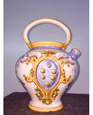Majolica pourer with mascaron handle decorated with plant motifs and festoons. Medici noble coat of arms. Ginori.     