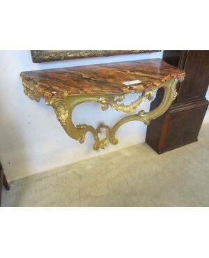 golden console with wooden floor marbled