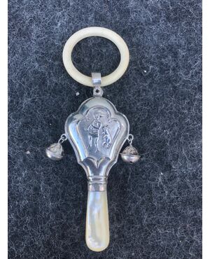 Silver baby rattle depicting a pied piper. Mother-of-pearl handle. Europe.     