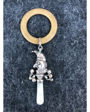 Silver baby rattle depicting jolly. Mother of pearl handle. England.     