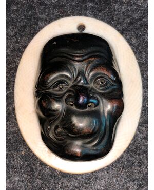 Small mask with grotesque bronze male figure.Japan     