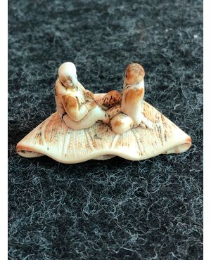 Netsuke &#39;in ivory depicting two characters sitting on a lotus leaf.Japan     