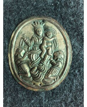 Brass tablecloth depicting the Madonna with Child and two hooded characters. Brotherhood of the Rosary.     