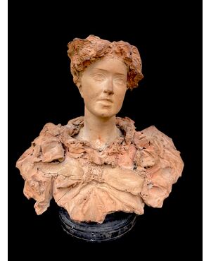 Scultura in terracotta raffigurante busto femminile.firma:Italo Campagnoli,data 1897. 