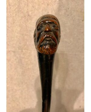 Single piece wooden stick depicting an Arab male figure     