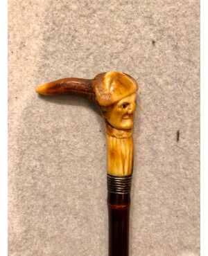 Stick with deer horn knob with grotesque male figure.     