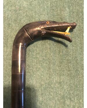 All-horn stick made up of segments on a flexible core depicting a snake.     