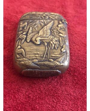 Brass matchbox with herons and birds in an art nouveau style lakeside setting.     