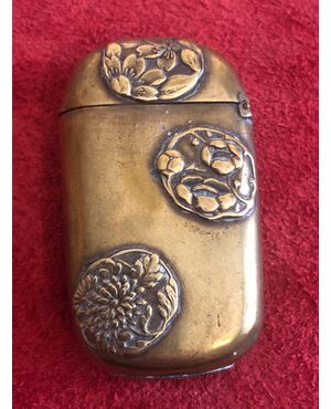 Brass matchbox with oriental floral motifs.     