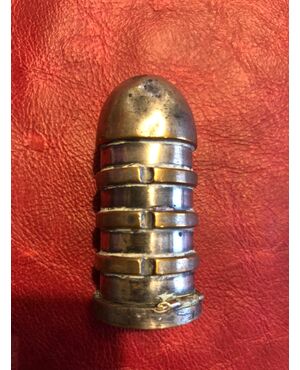 Silver plated copper matchbox in the shape of a grooved ogive.     