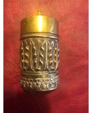 Cylindrical brass matchbox with stylized vegetable decorations.Vesta, England.     