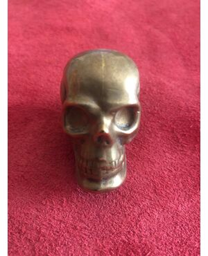 Brass matchbox in the shape of a skull.     