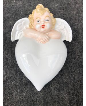 Porcelain stoup in the shape of a heart with a puttino.Germania.     