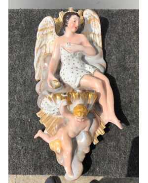 Porcelain holy water stoup with seated angel holding shell and putto.France.     