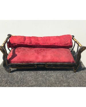 Wooden sofa model with gold decorations.     