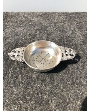 Silver colander with two perforated handles with stylized plant motifs. Silversmith Martini from Rome.     