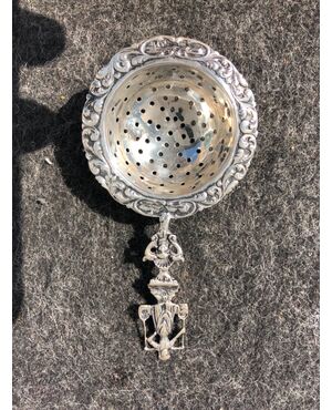 Silver colander decorated with popular character and stylized plant motifs. Holland.     