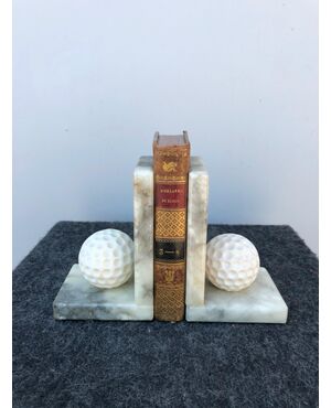 Pair of alabaster bookends depicting golf balls.     