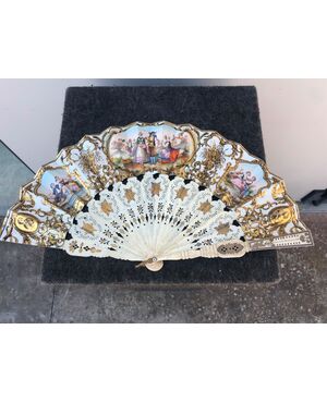 Openwork and gilded ivory fan with Pavese in paper with watercolor prints with gallant and country scenes. France.     