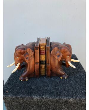 Pair of teak wood bookends depicting a pair of elephants. Ivory tusks.     