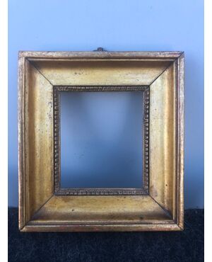 Small frame in carved and gilded wood.     