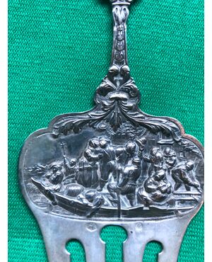 Fork in embossed silver with characters on a boat, mascarons and stylized plant motifs. Holland 1860.     