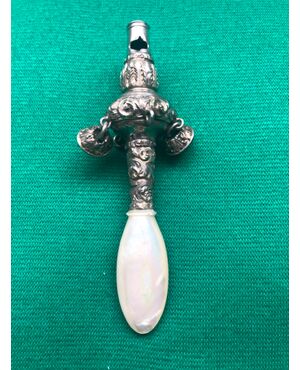 Silver baby rattle with stylized plant motifs. Mother of pearl handle.     