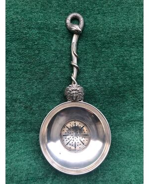Silver tea strainer with neoclassical mask and snake.     