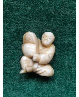 Ivory netsuke &#39;with seated figure and infant. Japan.     