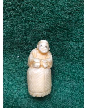 Ivory netsuke &#39;with character sitting on a wicker basket. Japan.     