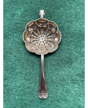 Tea stand in silver with pods and stylized plant motifs.     