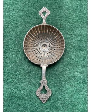 Tea strainer in poded silver with stylized plant motifs.Germany.     