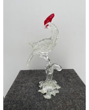 Bird in transparent glass with bubbles and variegations with red details.Murano     