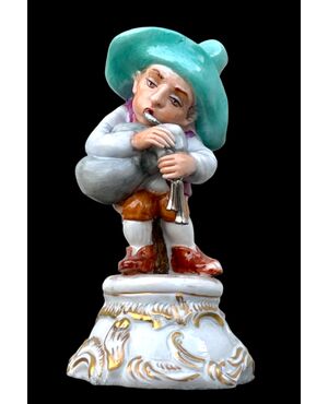 Figura di gobbo in porcellana che suona zampogna. Manifattura Fabris.Milano.