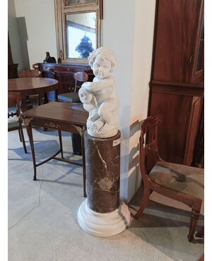 Gray marble column with white marble cherub statue