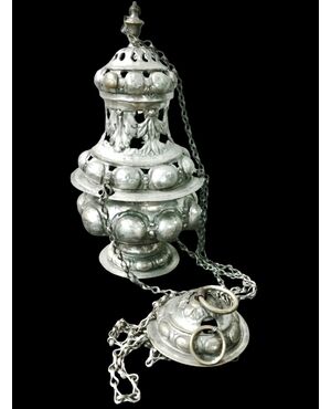 Silver-plated metal thurible with openwork, bosses, and stylized leaves.