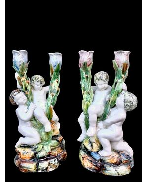 Pair of two-light majolica candlesticks with putti. Minghetti manufacture. Bologna.