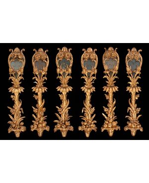 Six palace wall lights in carved and gilded wood and glass