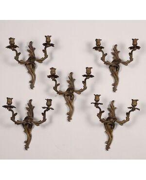 Group of five two-light bronze sconces. 19th century