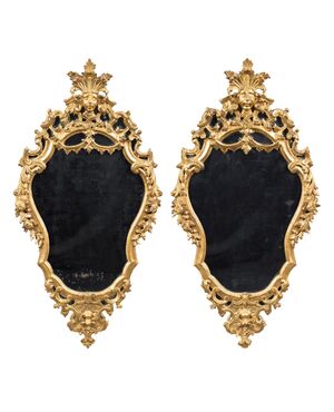 Pair of carved and gilded wooden mirrors. Italy, 18th century.