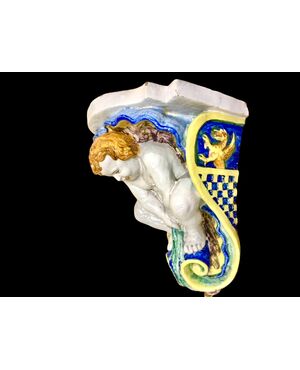 Pair of majolica shelves with cherubs and shell motifs. Rubbiani manufacture of Sassuolo.