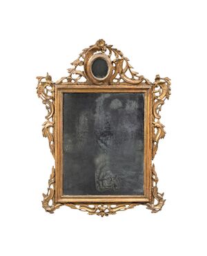 Carved and gilded wooden mirror. Venice, 18th century.