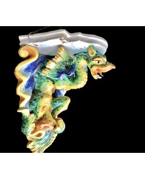 Majolica shelf with support in the shape of a winged dragon. Imola manufacture.